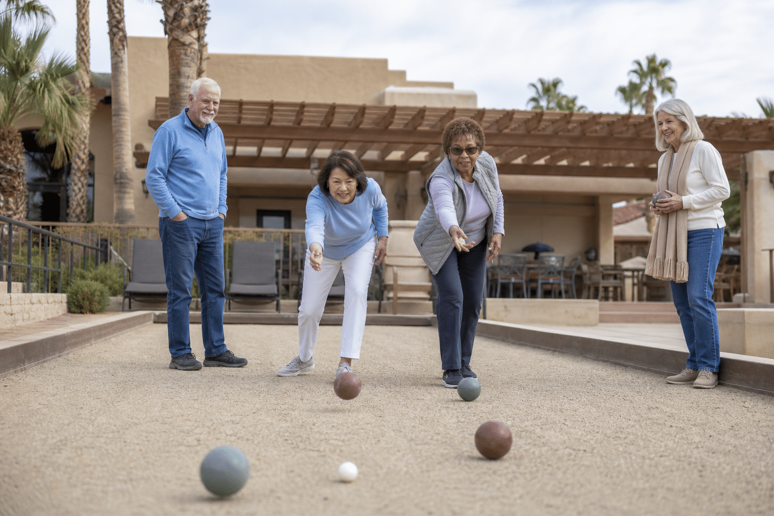four Trilogy at Power Ranch residents playing a relaxed bocce match on outdoor courts beside the San Tan Club in Gilbert, Arizona